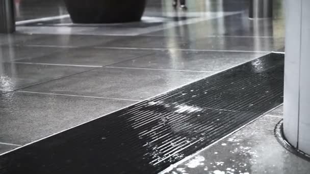 Asian pedestrians walking through rain in business district area on wet floor - Filmmaterial, Video