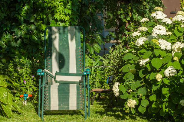 chaise portable dans le jardin, chaise confortable, généralement rembourrée, avec supports latéraux pour les bras d'une personne
. - Photo, image