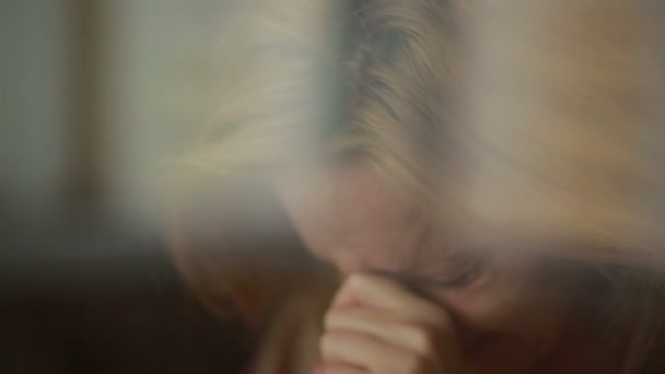 Sad girl near window. plachet woman. tears in schekah - Video, Çekim