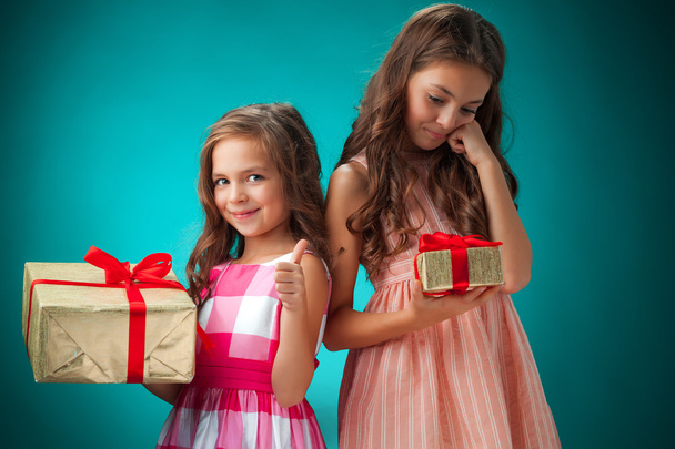 The two cute cheerful little girls on blue background - Φωτογραφία, εικόνα