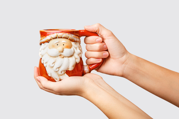 Woman holds a winter cup close up. Holding a cozy mug.Winter and - 写真・画像