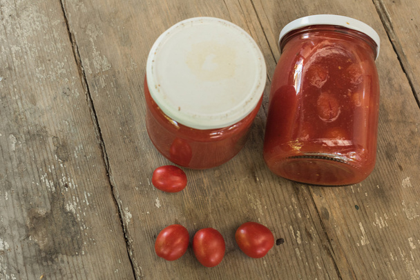Tomatoes preserved in glass jars - Photo, Image