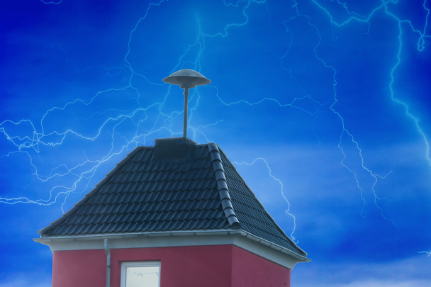 Blitze über einem kleinen Turm mit Luftschutzsirene          - Foto, Bild