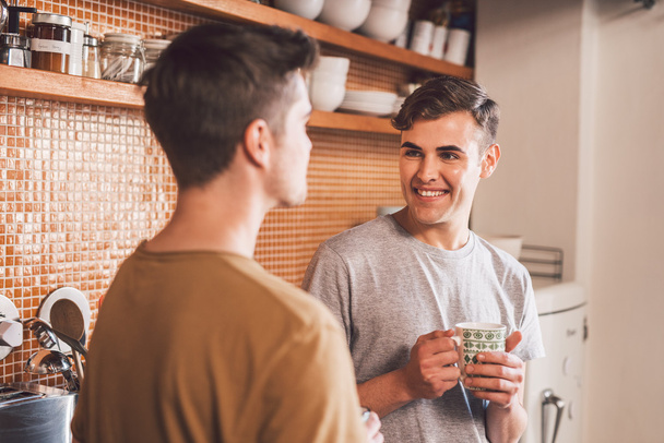 gay couple drinking coffee and talking - 写真・画像