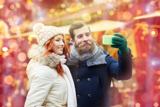 couple taking selfie with smartphone in old town - Fotó, kép