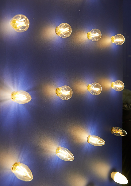 Lamps of different sizes and shapes. A booth to showcase led lamps. Lamp sticking out of wall. - Φωτογραφία, εικόνα