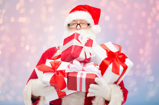 man in costume of santa claus with gift boxes - Фото, изображение
