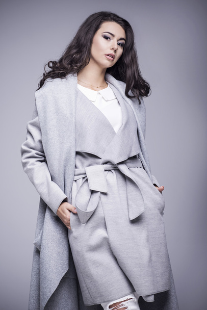 Beautiful young woman in an elegant gray coat - Photo, Image