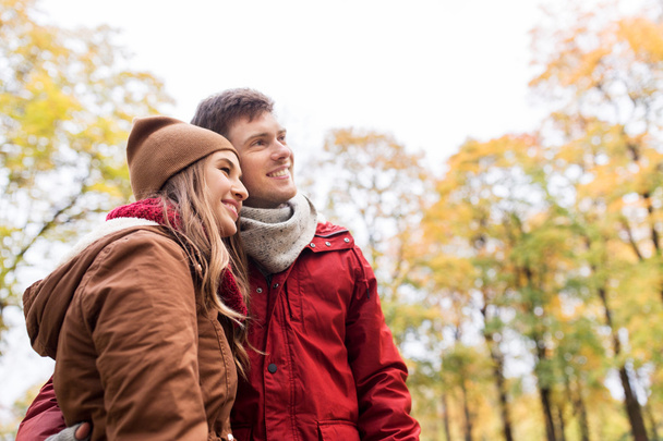 happy young couple walking in autumn park - Fotó, kép
