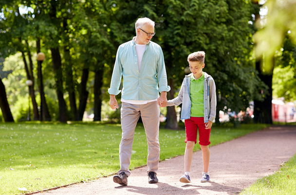 grandfather and grandson walking at summer park - Foto, Imagem