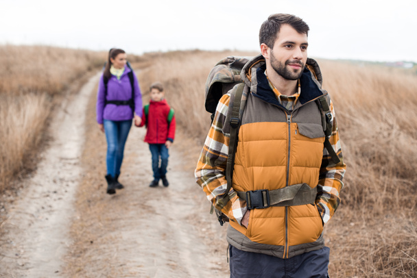 Man with wife and son backpacking - 写真・画像