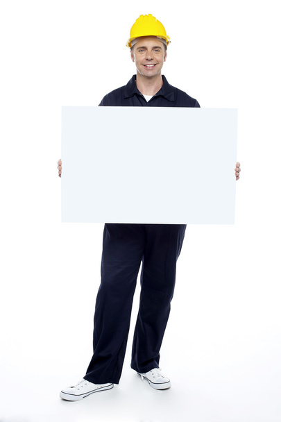 Repairman holding blank billboard, full length portrait - Φωτογραφία, εικόνα