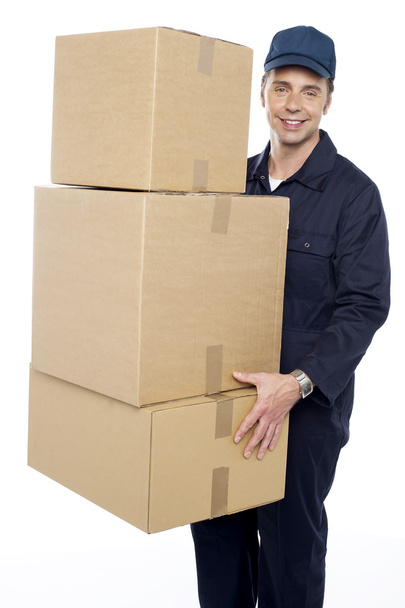 Working man delivering stack of cardboard boxes - Zdjęcie, obraz