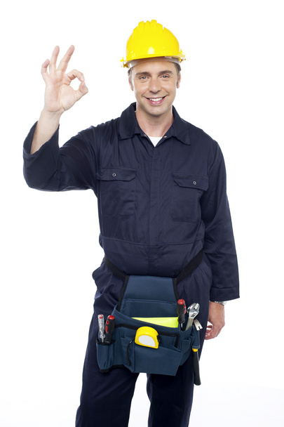 Senior repairman showing good work done sign - Фото, изображение