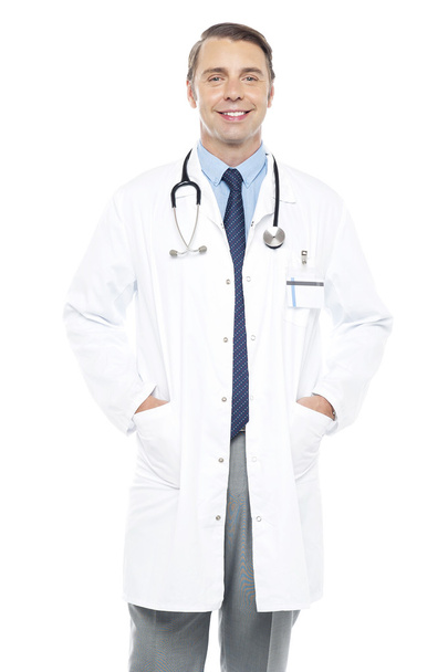 Young doctor posing with hands in his overcoat - Zdjęcie, obraz