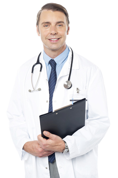 Smiling professional physician carrying clipboard - Foto, Imagen