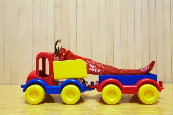 Toy plastic car with red pepper - Zdjęcie, obraz