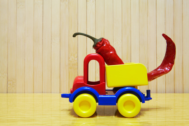 Toy plastic car with red pepper - Zdjęcie, obraz