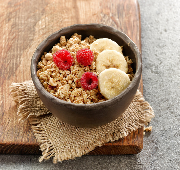 bowl of granola with banana and raspberries - Photo, Image