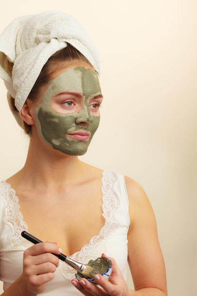 Woman applying with brush clay mud mask to her face  - Φωτογραφία, εικόνα