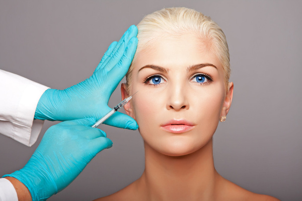 Cosmetic plastic surgeon injecting aesthetics face - Zdjęcie, obraz