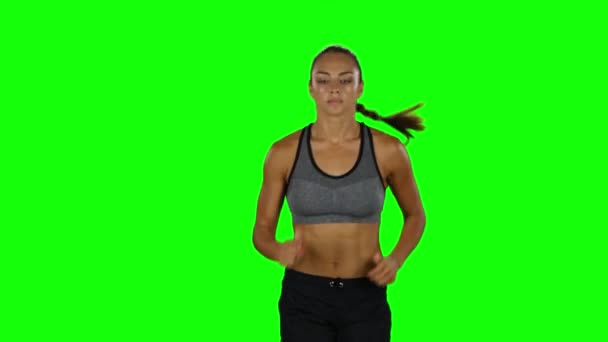 Girl with athletic body running. Front view. Green screen - Felvétel, videó