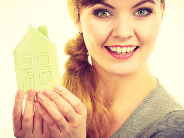 Smiling girl with home symbol. - Foto, Bild