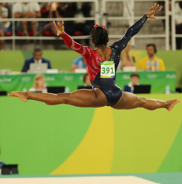Olympic champion Simone Biles of United States competes on the floor exercise during women's all-around gymnastics qualification  - Valokuva, kuva