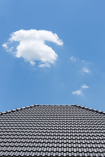 black tile roof on house with clear blue sky and cloud backgroun - Photo, Image