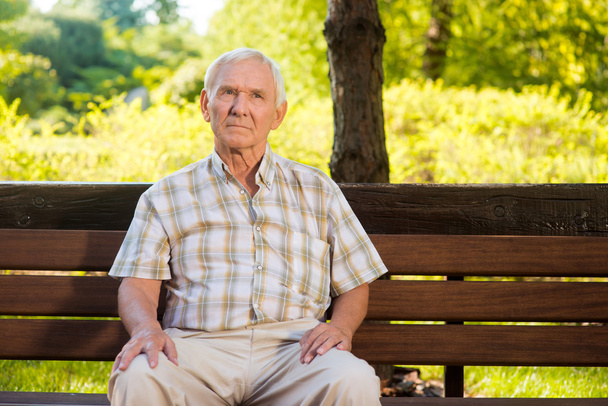 Old man sitting on bench. - Φωτογραφία, εικόνα