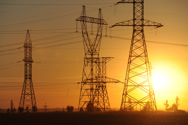 High-voltage power transmission line. Energy pillars. At sunset, - Photo, Image