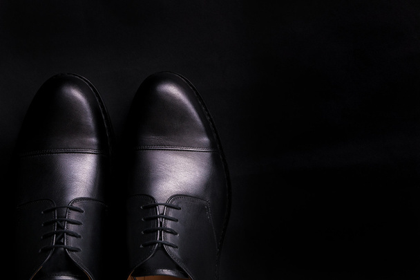 Black oxford shoes on  background. Top view. Copy space. - 写真・画像
