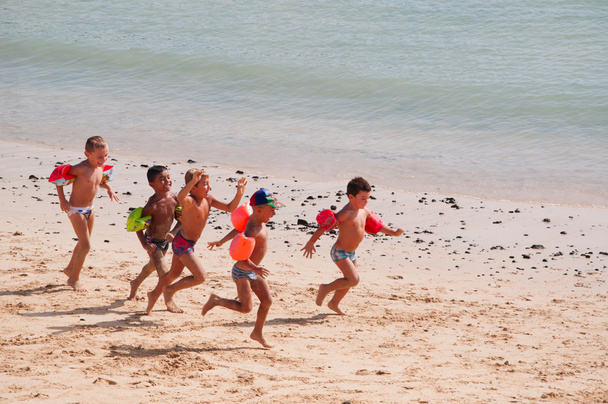 Фуертевентура, Канарські острови, Іспанія: група дітей, що грають по пляжу Корралехо, одним з найважливіших туристичних міст на півночі острова - Фото, зображення