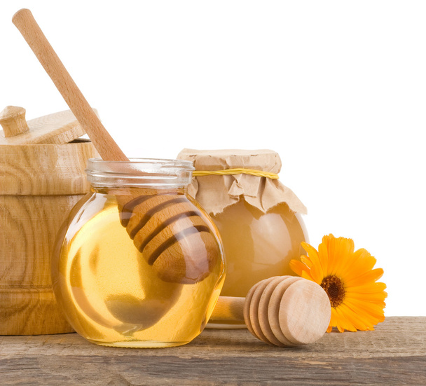 honey in glass and wood pot isolated on white - Fotoğraf, Görsel