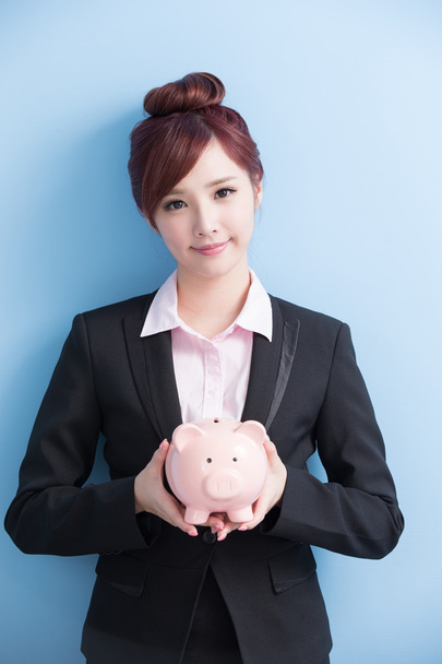 woman take pink piggy bank  - Фото, зображення
