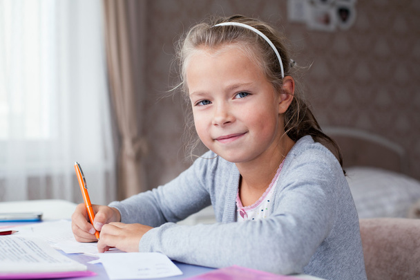 little school girl doing homework - Foto, immagini