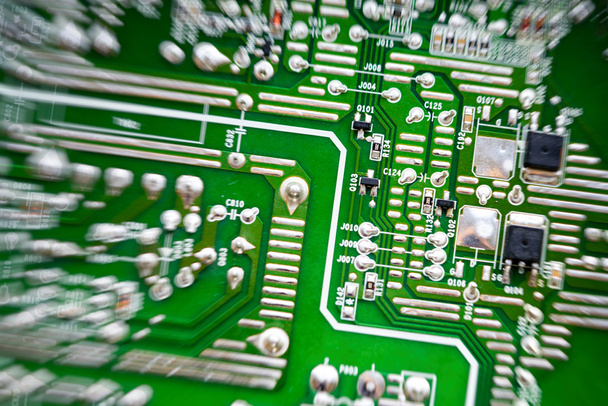 green circuit board representative of the high tech industry and computer science, top view, radial blur effect, center off-side. - Photo, Image
