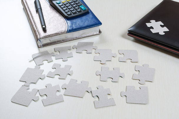 puzzle elements are scattered on the desk in the office - Photo, Image