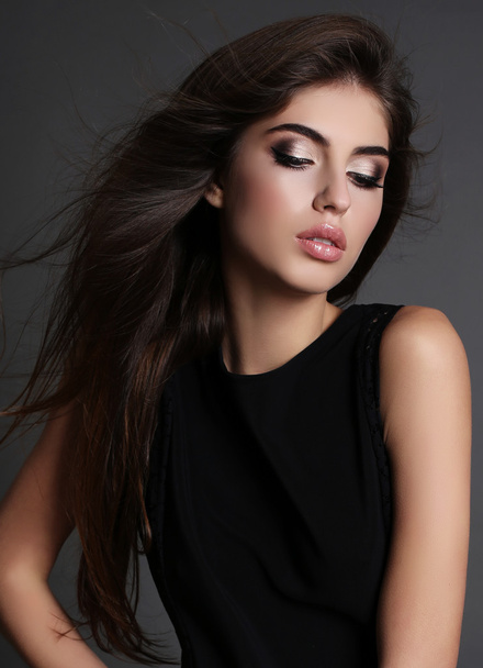 beautiful girl with dark hair and bright makeup in elegant dress  - Фото, зображення