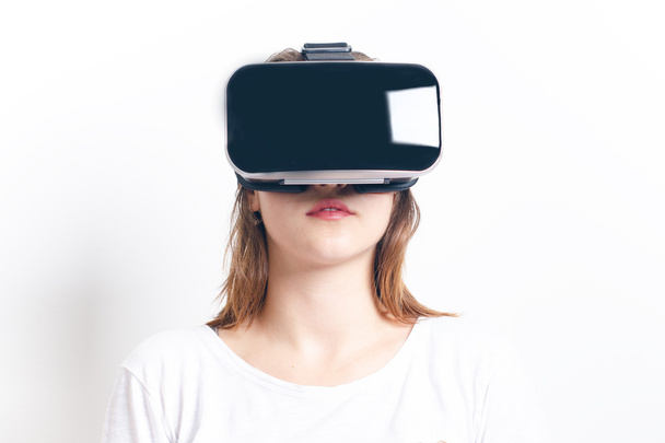 Woman with virtual reality goggles. Isolated. White background. Studio Woman show a gesture.  - 写真・画像