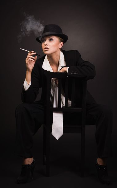 Adult woman smoking cigarette in bar - Photo, Image