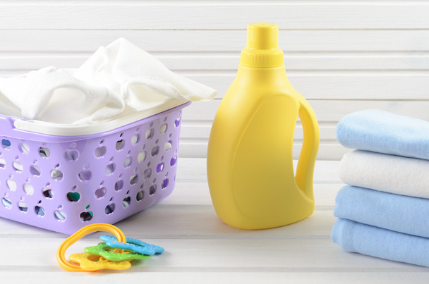 Dirty baby napkins in a plastic purple laundry basket, clean fol - Fotografie, Obrázek