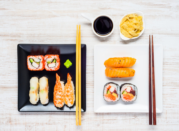 Sushi on Two Plates with Soy Sauce and Ginger - Foto, afbeelding