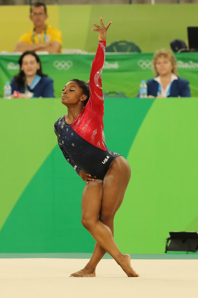 Olympic champion Simone Biles of United States competes on the floor exercise during women's all-around gymnastics qualification at Rio 2016 Olympic Games - Valokuva, kuva