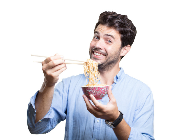 Young man eating sushi on white background - Photo, Image