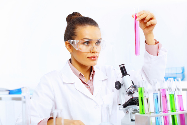 Young female scientist working in laboratory - Фото, изображение