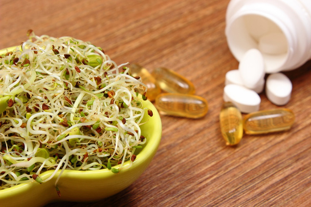 Alfalfa and radish sprouts with tablets supplements, healthy nutrition - Photo, Image