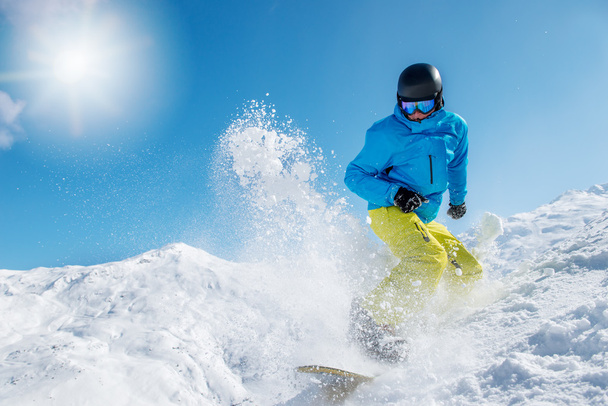 Active young man snowboarding - Фото, изображение