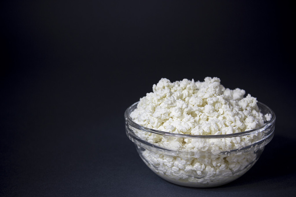 Cottage cheese in a glass bowl. Background. Space for text - Fotografie, Obrázek