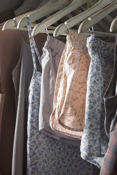 Homemade clothes of different colors hanging in the store - 写真・画像
